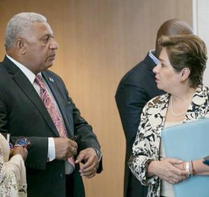 Prime Minister Frank Bainimarama, and COP 23 President, Fiji, and UNFCCC Executive Secretary Patricia Espinosa speak in a hallway at the Bonn Climate Conference, May 7, 2018 (Photo courtesy Earth Negotiations Bulletin) Used with permission