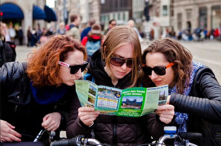 Visitors to The Netherlands explore Amsterdam by bicycle, April 7, 2017 (Photo by Huub Zeeman) Creative Commons license via Flickr