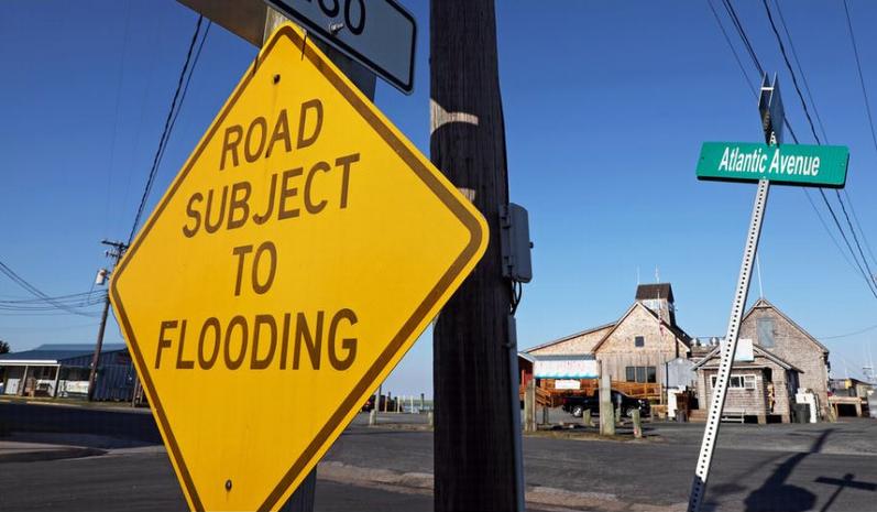 Road sign warns of flooding in Wachapreague, Virginia on Tuesday, July 10, 2018. (Photo by Aileen Devlin / Virginia Sea Grant) Creative Commons license via Flickr