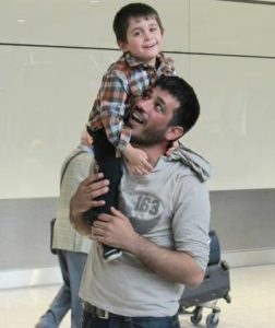 Khaled is reunited with his son at the airport under the IOM-British Red Cross Family Reunification program. 2019 (Photo courtesy British Red Cross) Posted for media use