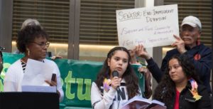 Child migrants speak of their experiences at a demonstration to honor all immigrants in front of the San Francisco office of U.S. Senator for California Kamala Harris, a Democrat, led by the Interfaith Movement for Human Integrity, April 18, 2019 (Photo by Peg Hunter) Creative Commons license via Flickr