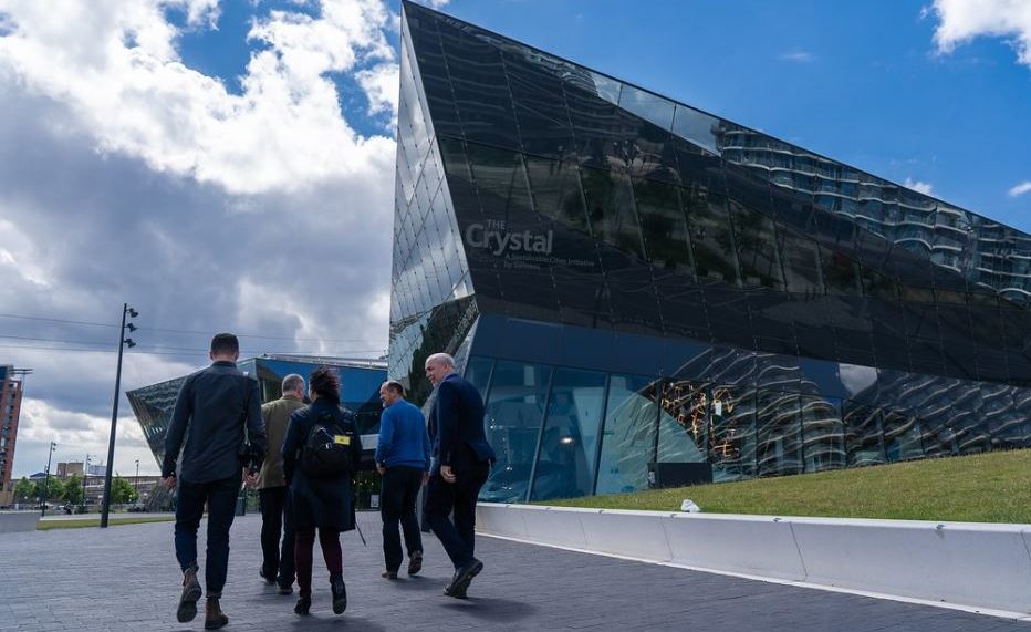 British Columbia Premier John Horgan tours one of Europe’s zero-emission buildings, the Siemens Crystal Building on London's Royal Victoria Docks. The Crystal is an all-electric building that uses solar power and a ground source heat pump to generate its own energy. It showcases state-of-the-art technologies to make buildings more efficient, incorporates rainwater harvesting, black water treatment, solar heating and automated building management systems. June 9, 2019. (Photo courtesy Province of British Columbia) Creative Commons license via Flickr