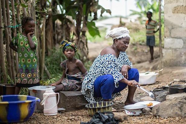 Hanna, a founding member and activist of MALOA (Malen Land Owners and Users Association) is preparing dinner in the kitchen of her home in Sahn Malen, Sierra Leone, West Africa, where there is no electricity or running water. December 12,2015 (Photo by FIANBelgium) Creative Commons license via Flickr