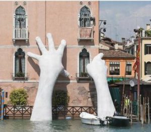 A smaller version of Lorenzo Quinn’s monumental sculpture “Support” was on display at the United Nations Climate Change Conference COP25 in Madrid to remind participants of rising sea levels that threaten Venice and all coastal cities. The installation, shown here, was first unveiled by Quinn at the Venice Biennale in 2017. Two gigantic hands of a child emerge from the Grand Canal in Venice to protect and support a historical building threatened by climate-induced flooding. Given the 50-year-record floods that hit Venice this month, Quinn’s alert is more urgent than ever. 2019 (Photo courtesy UNFCCC)
