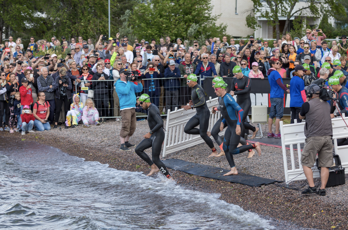 In the world's happiest country, Finland, triathletes run into Lake Vesijärvi for their Ironman Swimming Competition, June 29, 2019 (Photo by Marco Verch) Creative Commons license via Flickr
