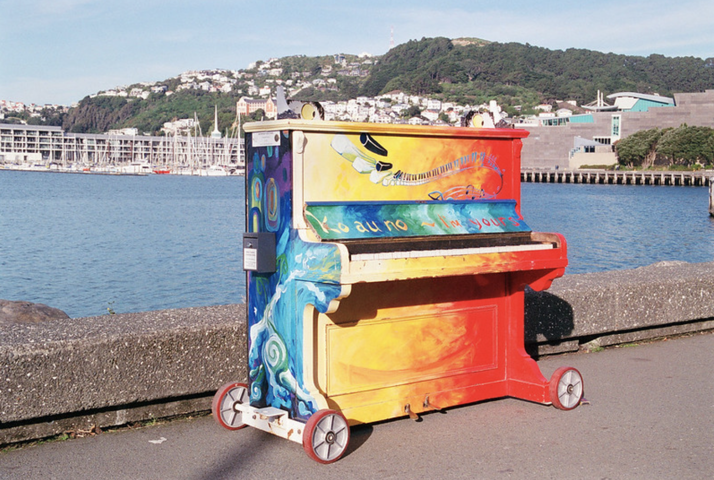 Anyone can walk up to and play this piano on a pier in Wellington, New Zealand, the world's third happiest city, August 2, 2019 (Photo by N.J. Cull) Creative Commons license via Flickr