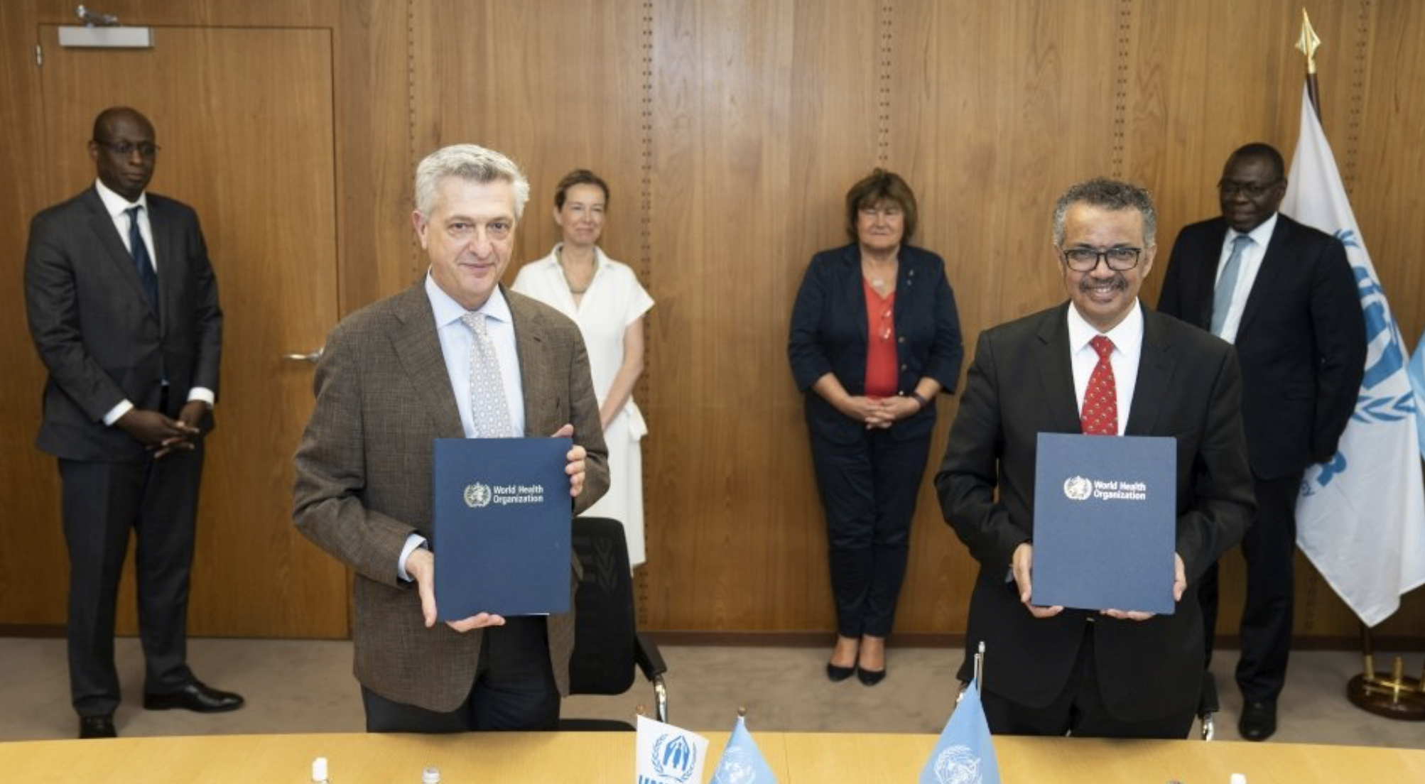 UN High Commissioner for Refugees Filippo Grandi (left) and Director-General World Health Organization Dr. Tedros Adhanom Ghebreyesus sign a Memorandum of Understanding on the integration of refugees in national health preparedness and response plans globally. May 21, 2020, Geneva, Switzerland (Photo by Christopher Black courtesy World Health Organization) Posted for media use 