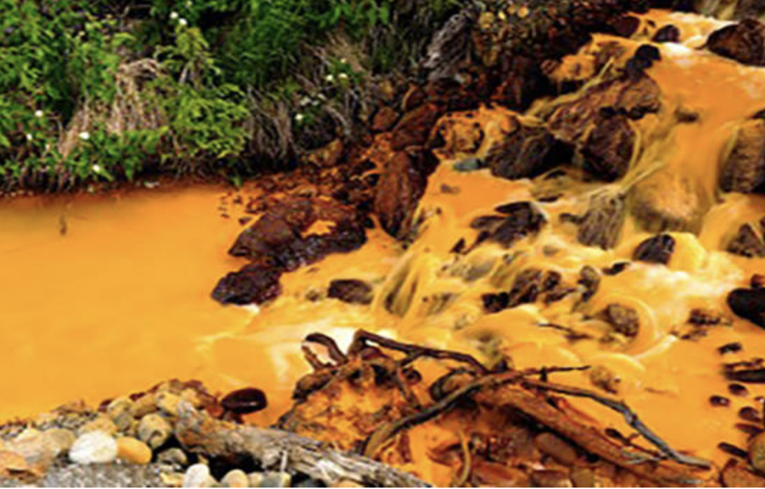 Acid mine drainage turns the water orange near the Tulsequa River, in northwestern British Columbia, Canada, 2018 (Photo courtesy U.S. Geological Survey) public domain