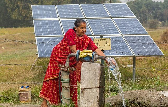 A farmer with her solar irrigation pump in Balahar Daha Village, Nepal, February 17, 2020 (Photo by Nabin Baral courtesy International Water Management Institute) Creative Commons license via Flickr