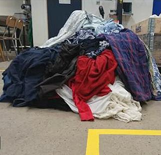 A heap of discarded cotton fabrics on the floor of the Lund University lab where Edvin Ruuth process them into a sugar solution that is the basis of a new nylon or spandex textile. February 2021 (Screengrab from video courtesy Lund University) Posted for media use   