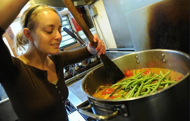 The cook smiles while preparing vegetarian green bean soup, Breitenbush Hot Springs, Breitenbush, Oregon, September 13, 2011 (Photo by Wonderlane) Public domain