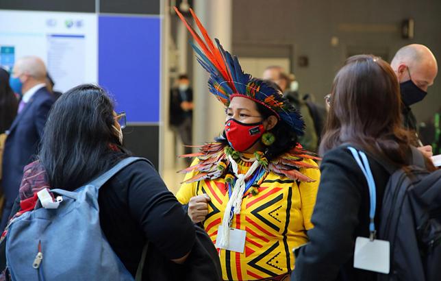 In the corridors and meeting rooms at the UN climate summit COP26, people from across the world network with people they would never have met otherwise, such as this indigenous woman, one of a group from Brazil. November 4, 2021 Glasgow, Scotland (Photo courtesy Earth Negotiations Bulletin) Posted for media use   https://enb.iisd.org/Glasgow-Climate-Change-Conference-COP26-04Nov2021  