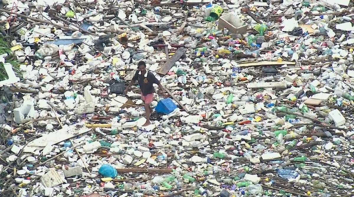 Source: The Indian Express, Man walking on garbage filled river in Brazil